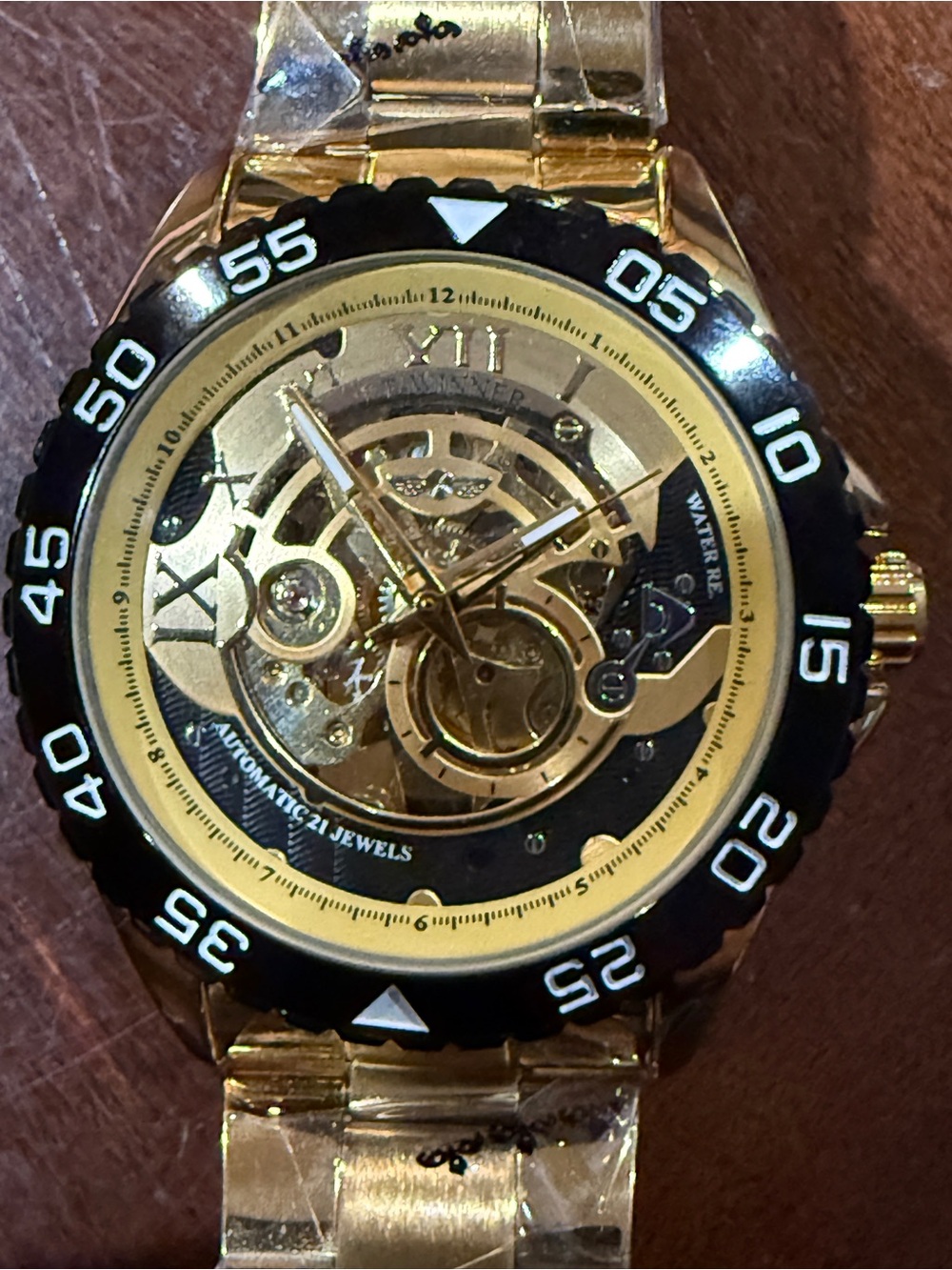 Men's Gold Skeleton Automatic Watch with Black Bezel